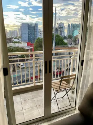 a balcony with a chair and a view of a city at 5 Star Luxury Condo - Metro Manila in Manila