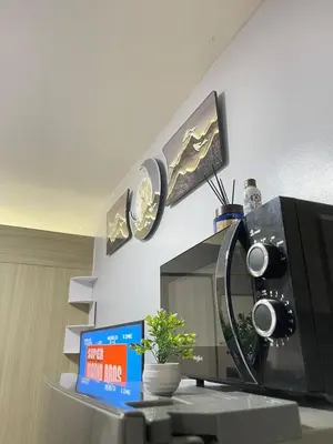 a microwave sitting on top of a table at Dandelion Shore Residences 1BR in Manila