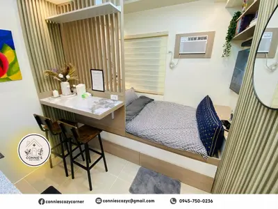 a small bedroom with a bed and a desk at Connie's Cozy Corner - Stylish Studio Unit in Cubao in Manila