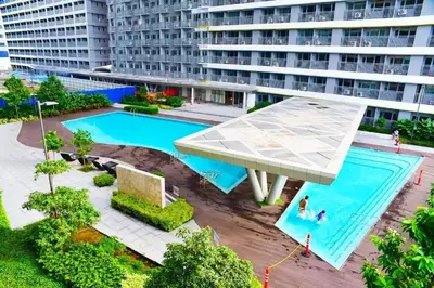 an overhead view of a swimming pool in a building at 1BR Condotel with Balcony at FAME Residences #FM10 in Manila