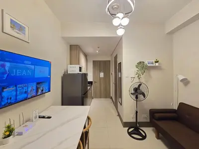 a living room with a table and a couch at 1BR Condotel with Balcony at FAME Residences #FM10 in Manila