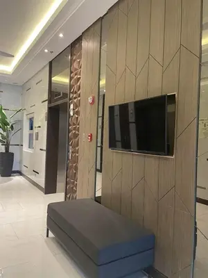a living room with a tv on a wooden wall at D&M cosy staycation in Manila