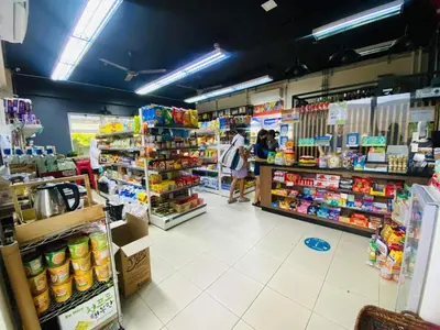 a store aisle with people in a grocery store at Scenic place to stay in manila 3618 in Manila
