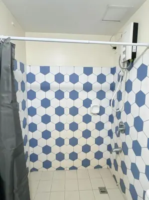 a bathroom with a blue and white checkered wall at Scenic place to stay in manila 3618 in Manila
