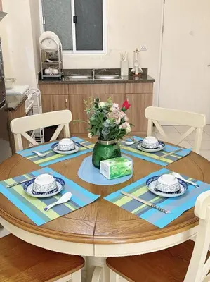 a wooden table with a vase of flowers on it at Scenic place to stay in manila 3618 in Manila