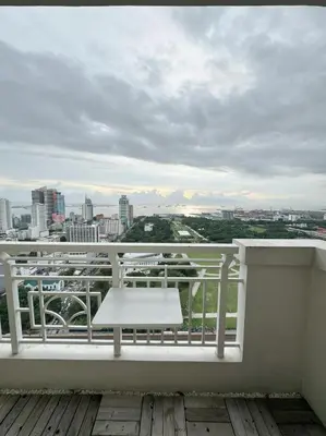 a white bench on a balcony with a view of a city at Scenic place to stay in manila 3618 in Manila