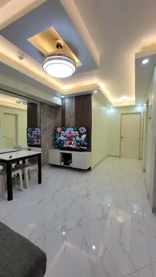 a living room with a table and a large marble floor at Levina Place 2BR Resort inspired in Manila