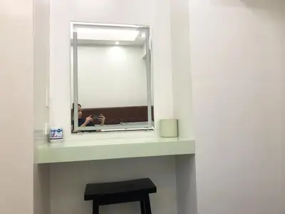 a mirror on a shelf in a bathroom with a stool at 1 BR Condo in Quezon City at Avida New Manila in Manila