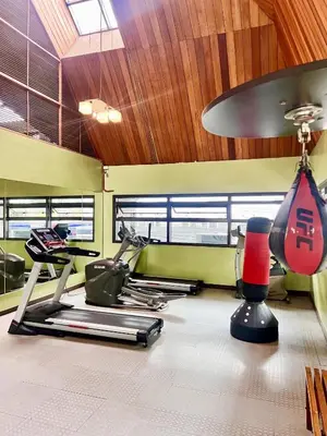 a gym with two exercise bikes and a treadmill at Prime Studio Unit at Robinson Magnolia 5 mins Walk to Mall-Netflix-KTV-WiFi in Manila