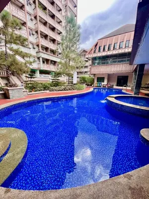 a large blue swimming pool in front of a building at Prime Studio Unit at Robinson Magnolia 5 mins Walk to Mall-Netflix-KTV-WiFi in Manila