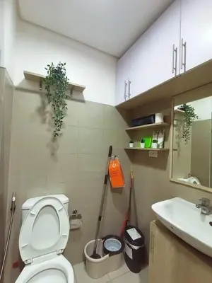a bathroom with a toilet and a sink at Cozy room for couple and family near mall of asia in Manila