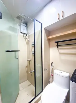 a bathroom with a shower and a toilet at Awesome Corner at Shore 3 Mall of Asia near Airport in Manila