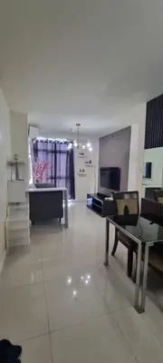 a living room with a couch and a table at Rikki Staycation in Manila