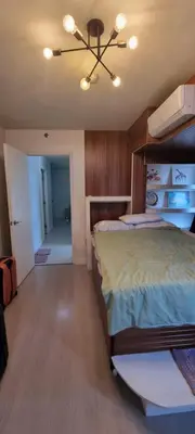a bedroom with a bed and a ceiling fan at Rikki Staycation in Manila