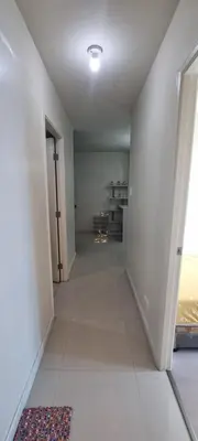 an empty room with a hallway with a door and a rug at Rikki Staycation in Manila