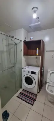 a bathroom with a toilet and a glass shower at Rikki Staycation in Manila