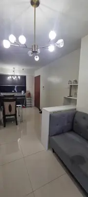 a living room with a couch and a ceiling fan at Rikki Staycation in Manila
