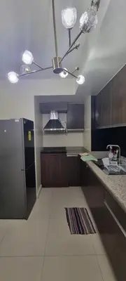a kitchen with a stainless steel refrigerator at Rikki Staycation in Manila