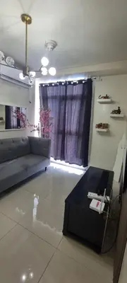 a living room with a couch and a table at Rikki Staycation in Manila