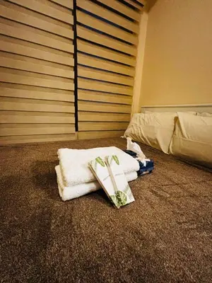 a bedroom with towels and a book on the floor at Relaxation Getaway in Manila