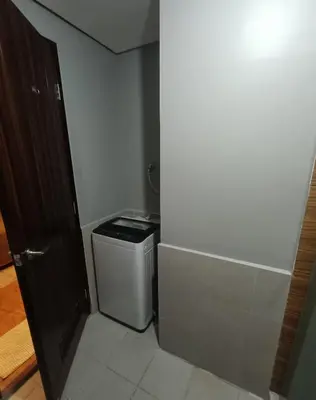 a small bathroom with a toilet and a trash can at Relaxation Getaway in Manila