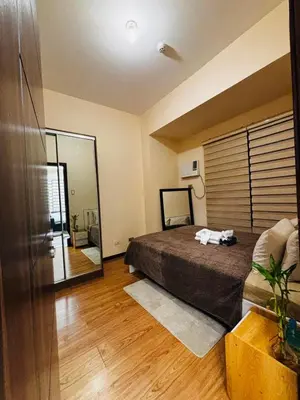 a bedroom with a bed and a large mirror at Relaxation Getaway in Manila