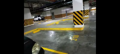 a parking garage with yellow lines on the floor at Shore Tower B in Manila