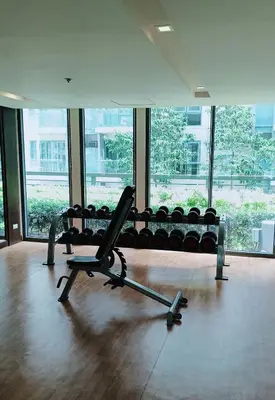 a gym with a bench in a room with windows at Budget Stay Across NAIA Terminal 3 C3-3G in Manila