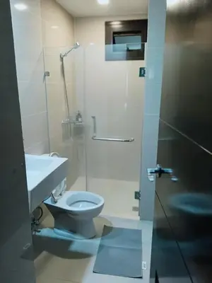 a bathroom with a toilet and a sink and a shower at Budget Stay Across NAIA Terminal 3 C3-3G in Manila