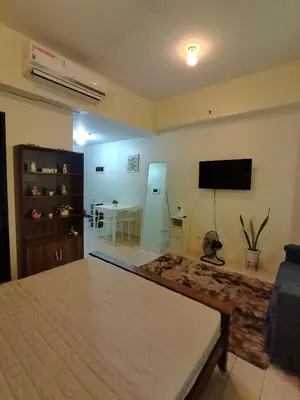 a living room with a bed and a flat screen tv at Budget Stay Across NAIA Terminal 3 C3-3G in Manila