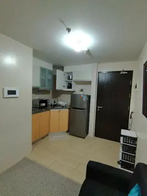 a kitchen with a refrigerator and a counter top at Budget Stay Across NAIA TERMINAL 3 C2-5J in Manila