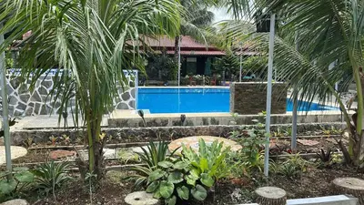 a resort with a swimming pool and palm trees at Lenjawi Resort and Events Place in Bitangan