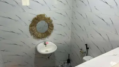 a bathroom with a sink and a mirror on the wall at Lenjawi Resort and Events Place in Bitangan
