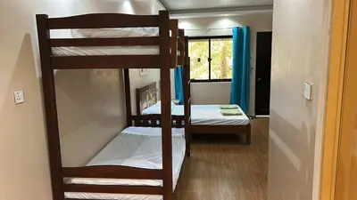 a room with two bunk beds and a window at Lenjawi Resort and Events Place in Bitangan