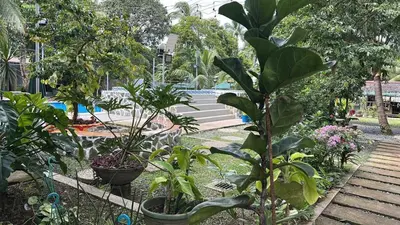 a garden with plants in pots and a fence at Lenjawi Resort and Events Place in Bitangan