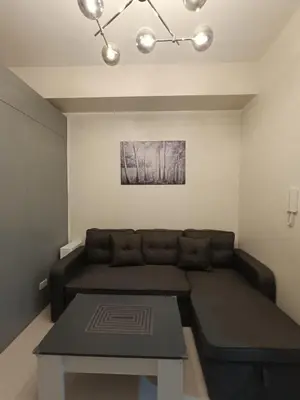 a living room with a couch and a table at Chino Roces Makati - Free Parking - Red Residences in Manila