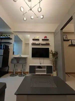 a living room with a flat screen tv on the wall at Chino Roces Makati - Free Parking - Red Residences in Manila