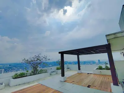 a view from the roof of a building with a wooden deck at The Beacon Condo at Makati CBD in Manila