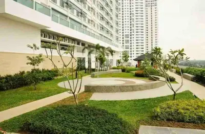 a garden in front of a large building at The Beacon Condo at Makati CBD in Manila