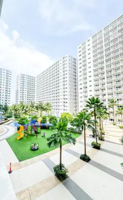 a playground in front of a large apartment building at Manila Daze in Manila