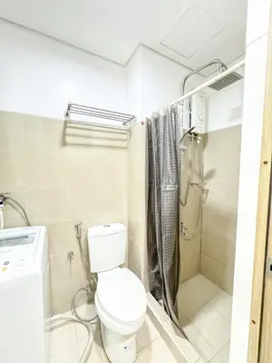 a bathroom with a toilet and a shower at Manila Daze in Manila