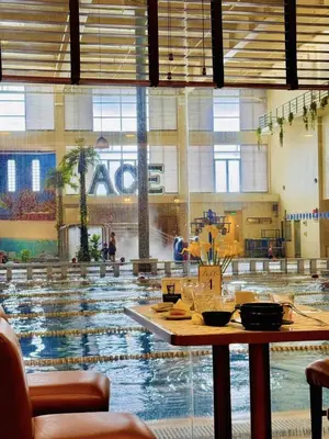 a large swimming pool with a table in front of it at Ace Suites by the WaterSpa - Budget Family Room in Manila