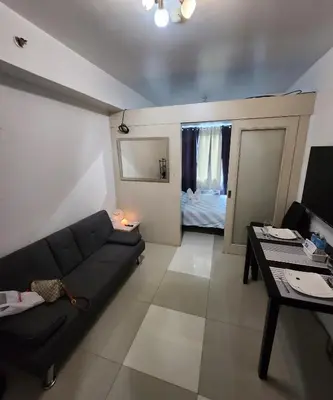 a living room with a couch and a table at MNM Place - Sea Residence 0D in Manila