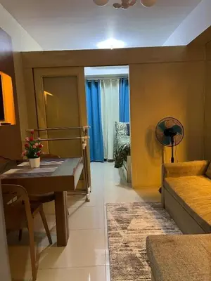 a living room with a table and a couch at MNM Place - Sea Residence 5A in Manila
