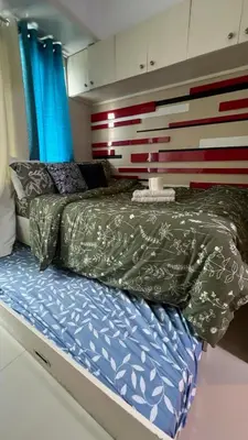 a small bed in a room with at MNM Place - Sea Residence 5A in Manila