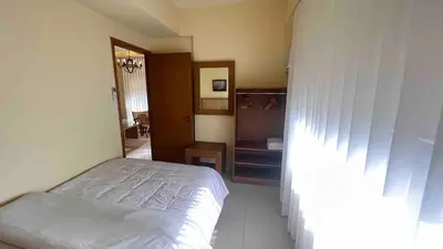 a small bedroom with a bed and a mirror at 3 Bedroom Beautiful and Spacious Penthouse in Makati in Manila