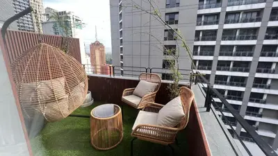 a balcony with chairs and tables on a building at 3 Bedroom Beautiful and Spacious Penthouse in Makati in Manila