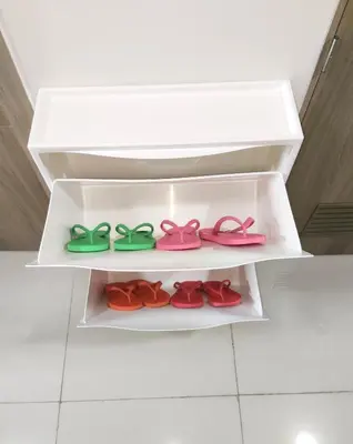 a white shelf with four different colored shoes at 2 Br Condo Apartment near PICC, CCP, WTC & Star City at Coast Residences, Pasay City in Manila