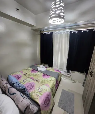 a bedroom with a bed and a window at MNM Place - Sea Residence 0A in Manila