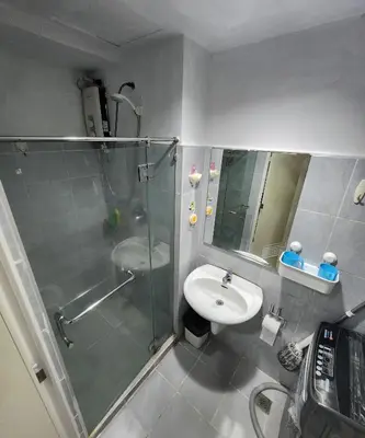 a bathroom with a glass shower and a sink at MNM Place - Sea Residence 0A in Manila